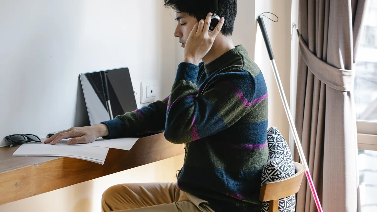 Photo of man using headphones with deep concentration