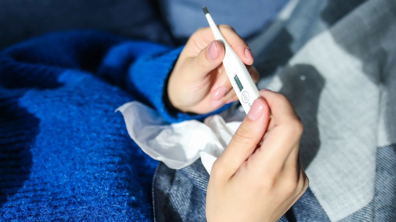 Person holding thermometer