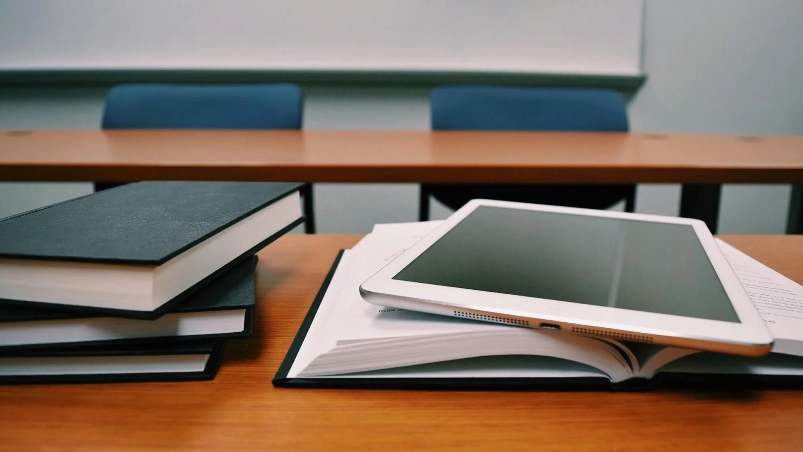 Silver ipad on white book page