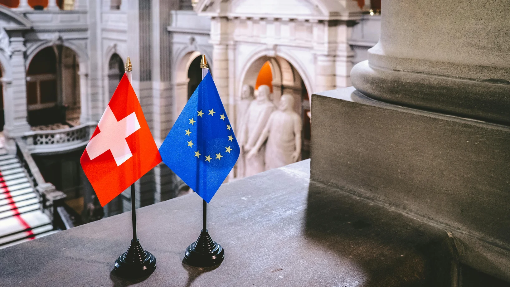 Switzerland and europian flags on black stands