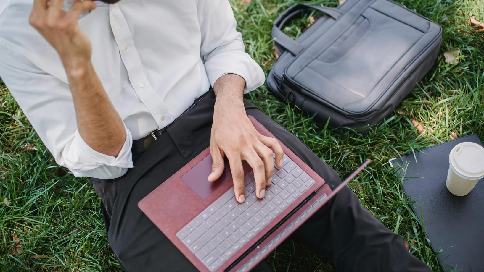 Businessman working with laptop in park