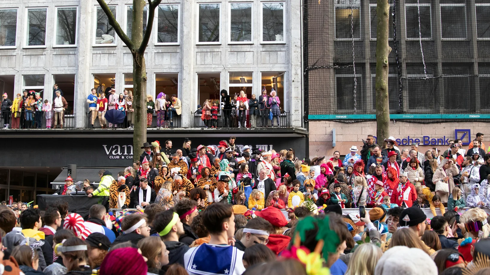 Vibrant carnival parade crowd celebrating in Cologne with costumes and festivities.